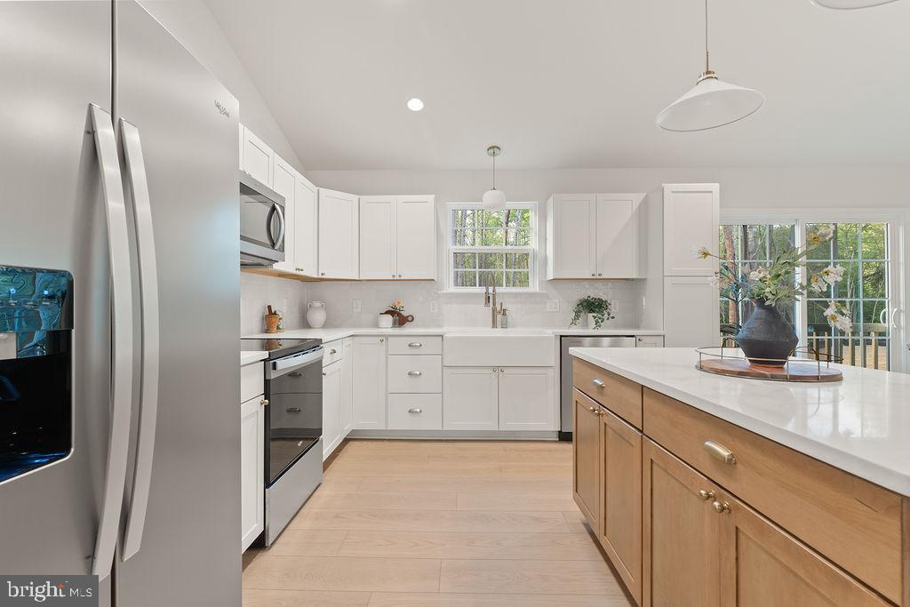729 Vawter Corner Road Louisa, VA 23093 - Photo 10 of 50 a kitchen with a sink window and cabinets