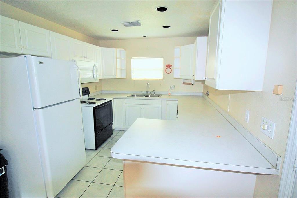 521 20th Street Southwest, Unit C Winter Haven, FL 33880 - Photo 4 of 18 a utility room with cabinets washer and dryer