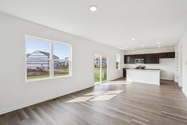a kitchen with a sink cabinets and wooden floor
