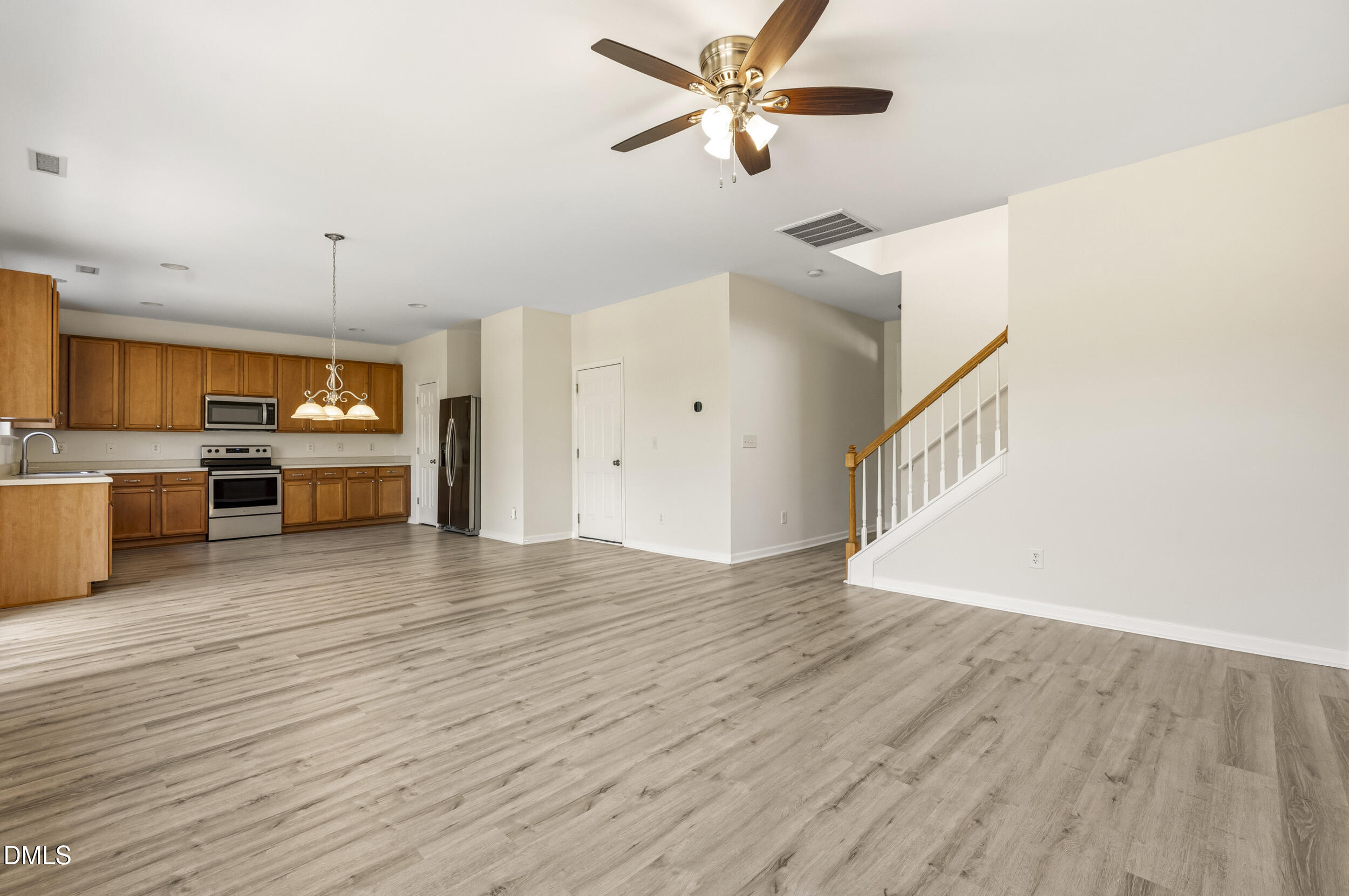 112 Ryder Cup Circle Raleigh, NC 27603 - Photo 6 of 45 a view of an empty room with a window and wooden floor