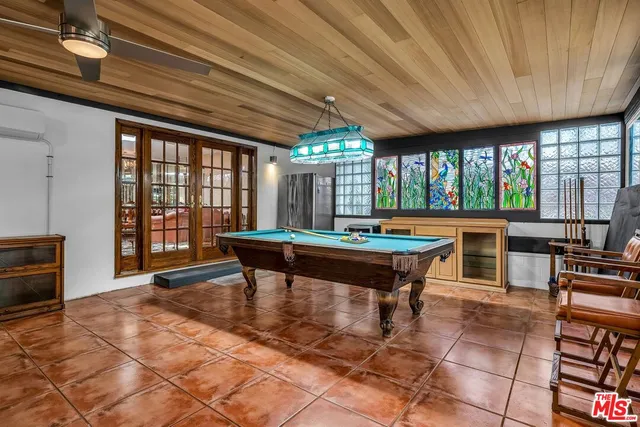 a living room with a table chairs and a barbeque