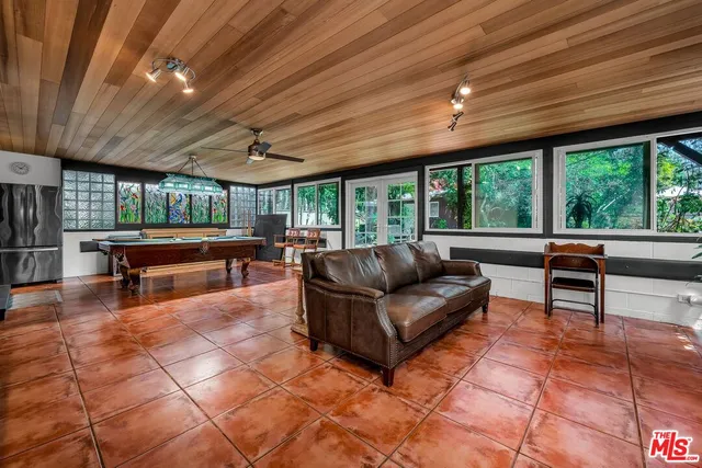a living room with furniture and a open kitchen view
