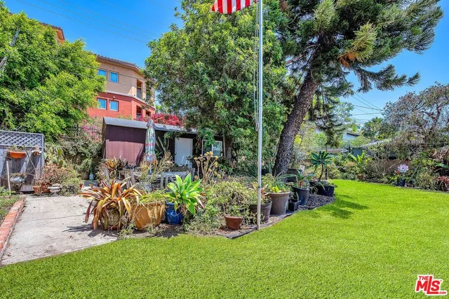 a view of a house with a yard and sitting area