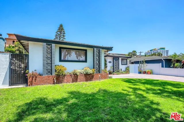 a front view of house with yard outdoor seating and green space