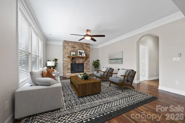 a living room with furniture a ceiling fan and a rug