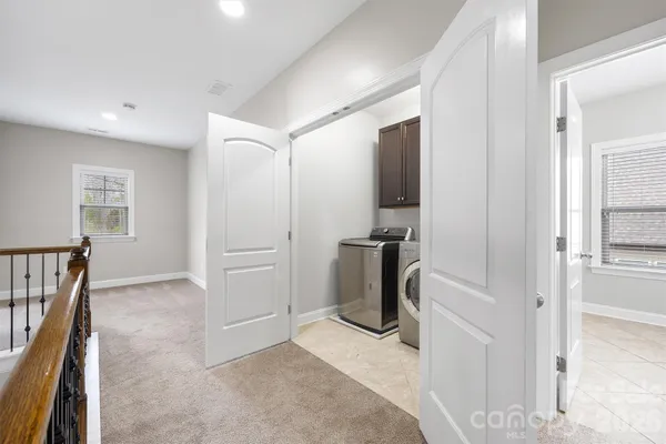 a bedroom with a large bed couch and a window