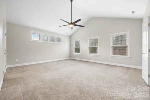 a view of empty room with ceiling fan