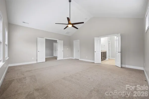 a bathroom with a granite countertop tub a sink and a large mirror