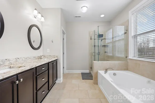 a white bath tub sitting next to a shower