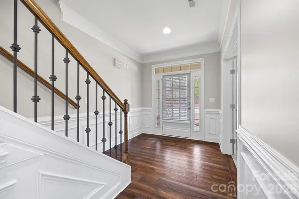 a view of an entryway with wooden floor