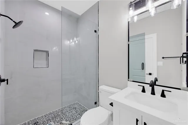 en empty room with windows and chandelier