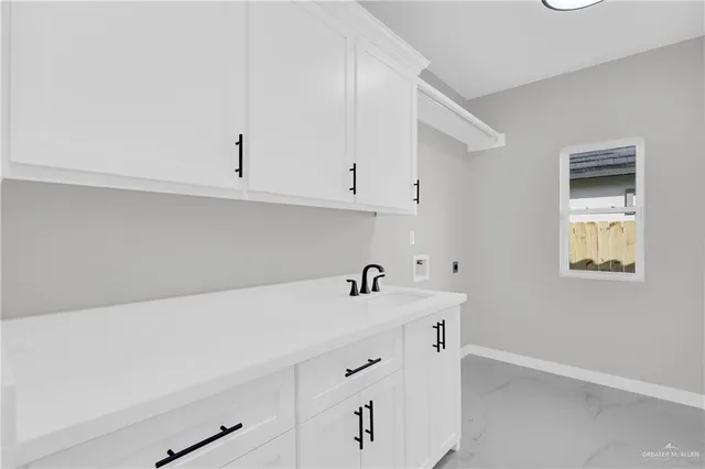 a view of an empty room with window and chandelier fan