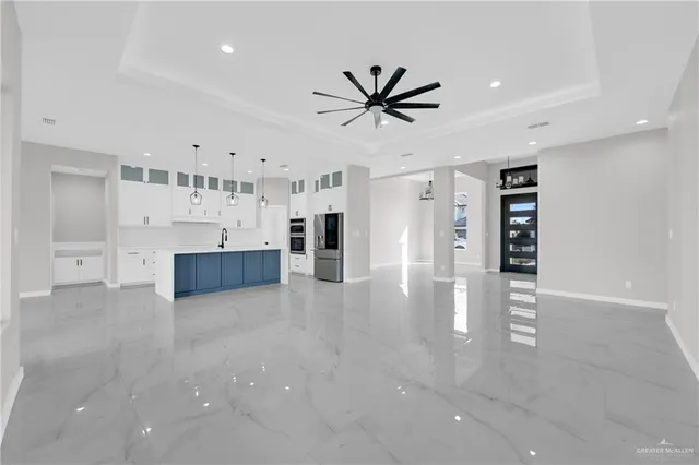 a view of empty room with wooden floor and window