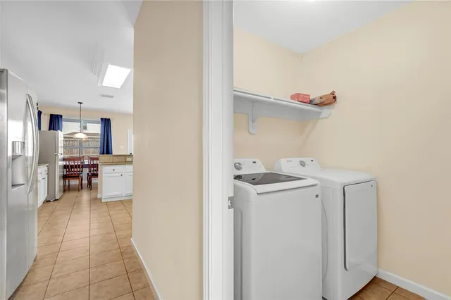 a utility room with cabinets washer and dryer