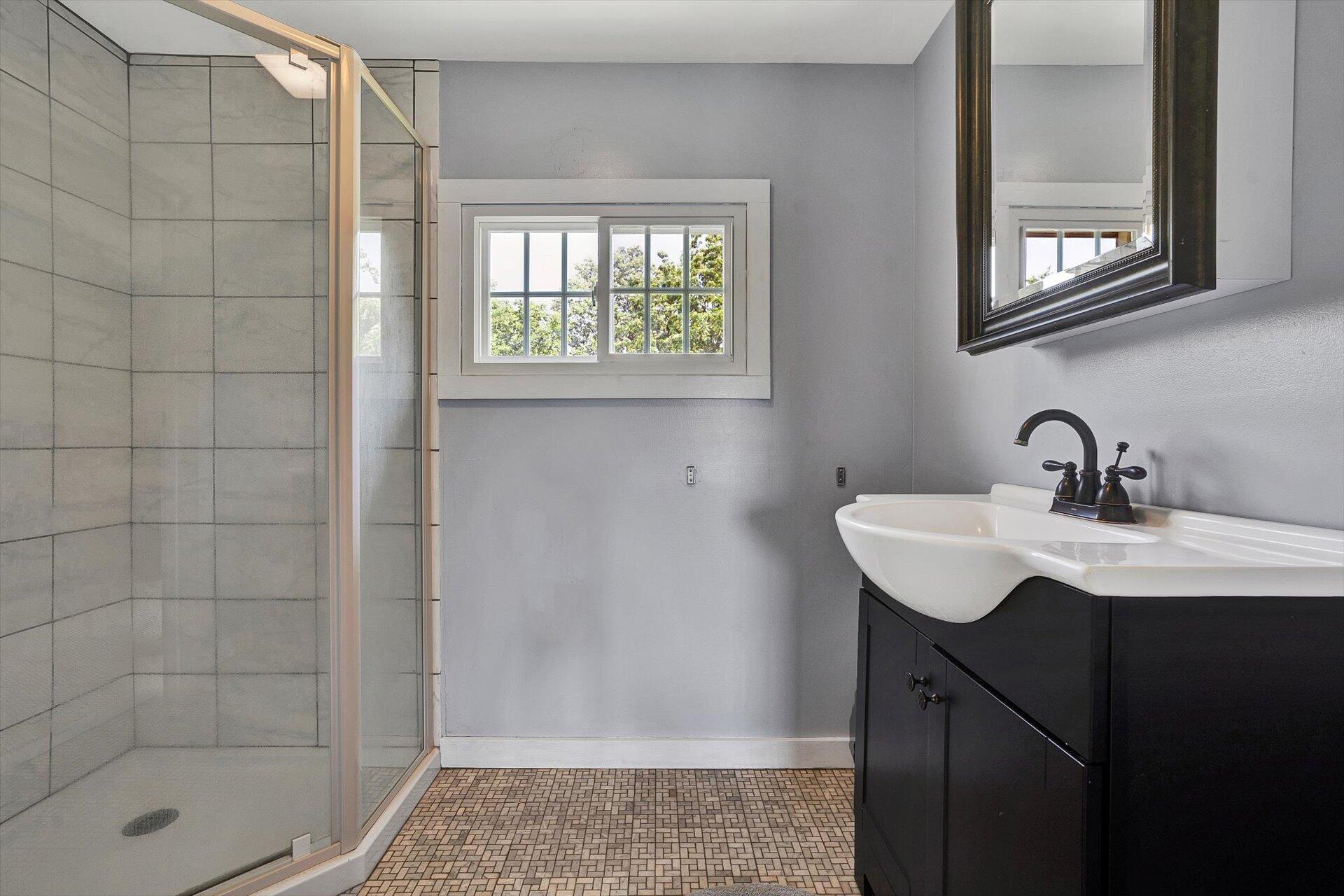2446 Deer Run Road Ferrum, VA 24088 - Photo 52 of 146 a bathroom with a sink a shower and a mirror