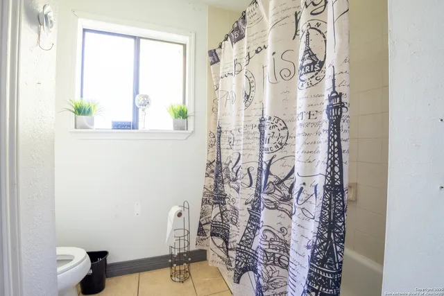 a bathroom with a shower curtain