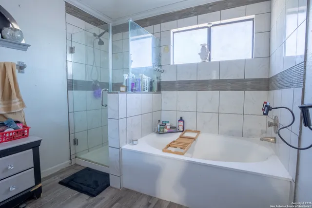 a bathroom with a bathtub and shower