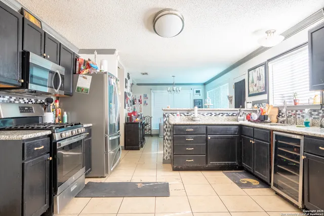 a kitchen with stainless steel appliances granite countertop a stove sink and cabinets