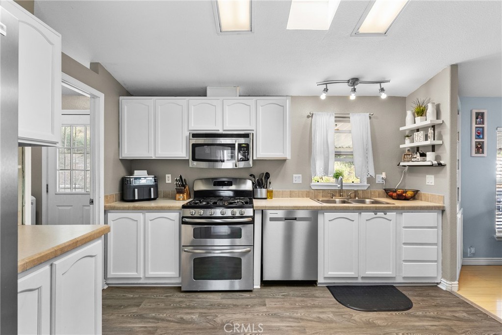 30000 Hasley Canyon Road, Unit 88 Castaic, CA 91384 - Photo 11 of 33 a kitchen with stainless steel appliances a stove sink and cabinets