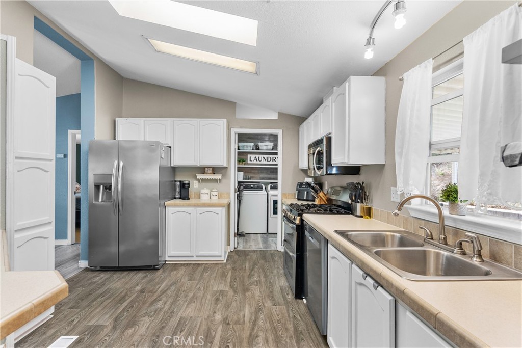 30000 Hasley Canyon Road, Unit 88 Castaic, CA 91384 - Photo 13 of 33 a kitchen with stainless steel appliances granite countertop a refrigerator a sink a stove a microwave and island