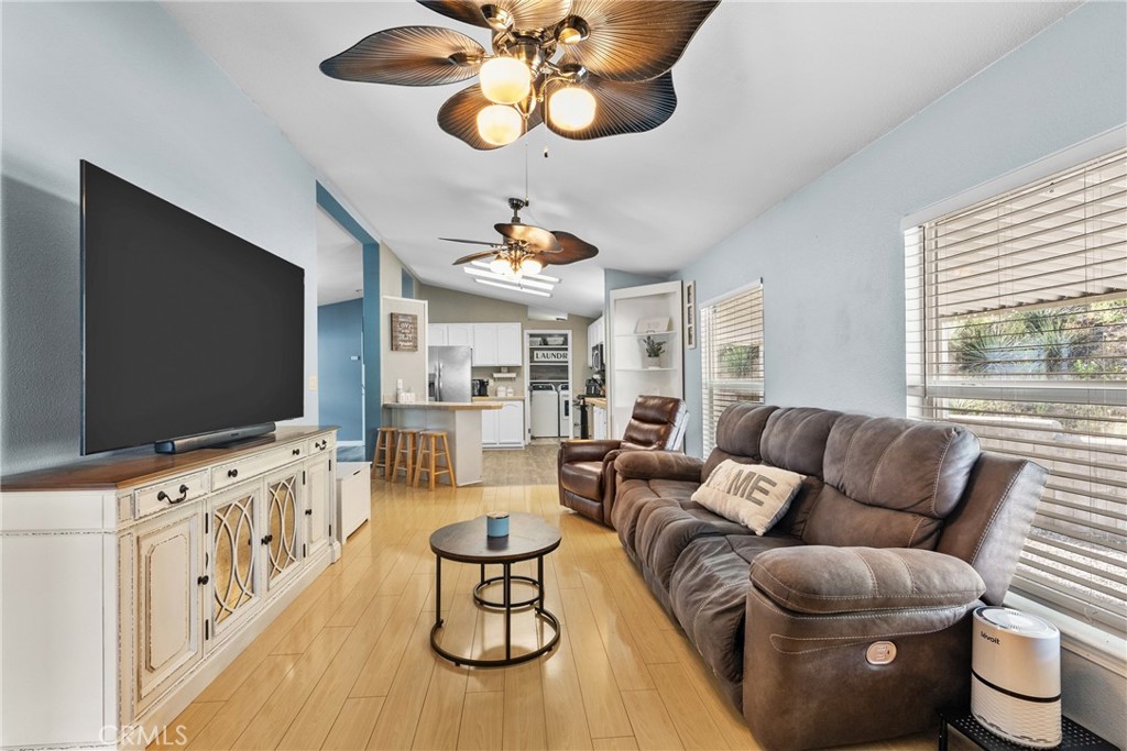 30000 Hasley Canyon Road, Unit 88 Castaic, CA 91384 - Photo 20 of 33 a living room with furniture a flat screen tv and kitchen view