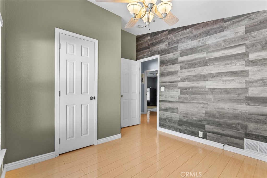 30000 Hasley Canyon Road, Unit 88 Castaic, CA 91384 - Photo 21 of 33 a view of a hallway with wooden floor and chandelier