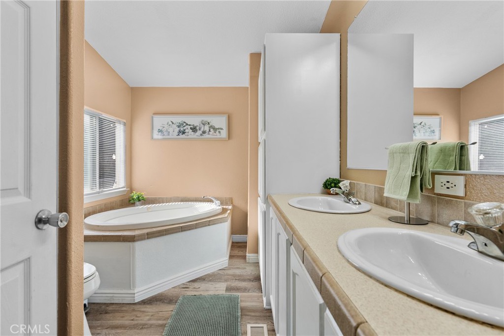 30000 Hasley Canyon Road, Unit 88 Castaic, CA 91384 - Photo 27 of 33 a bathroom with a sink a toilet and mirror