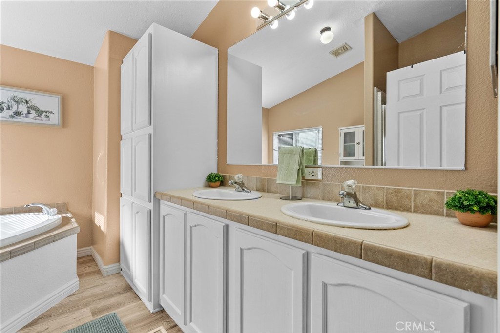 30000 Hasley Canyon Road, Unit 88 Castaic, CA 91384 - Photo 28 of 33 a bathroom with a granite countertop sink and a mirror