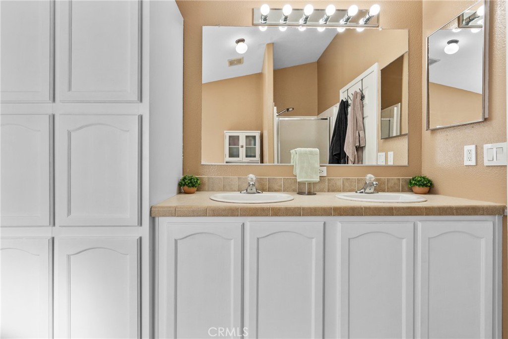 30000 Hasley Canyon Road, Unit 88 Castaic, CA 91384 - Photo 29 of 33 a bathroom with a double vanity sink and a mirror