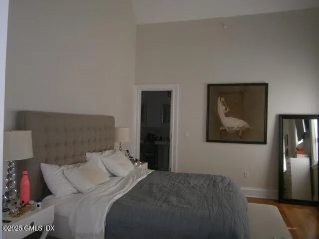 a bedroom with a bed and wall painting