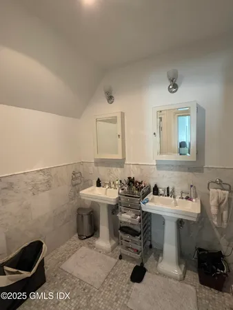 a bathroom with a sink toilet and a mirror