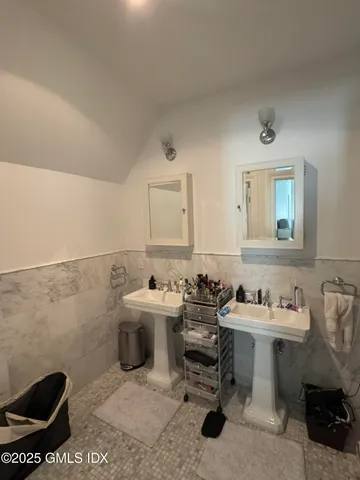 a bathroom with a sink toilet and a mirror