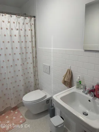 a white toilet sitting next to a bathroom sink