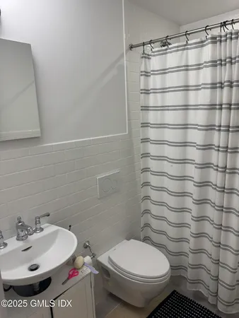 a bathroom with a toilet and a sink