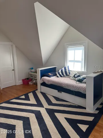 a bedroom with a bed and a mirror