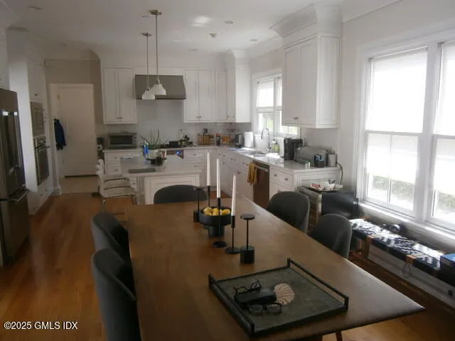 a kitchen with stainless steel appliances granite countertop a sink a stove and a refrigerator