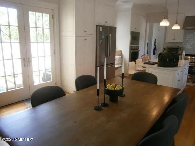 a kitchen with dining table and chairs
