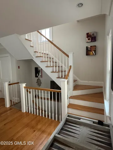 a view of entryway livingroom and hall with wooden floor