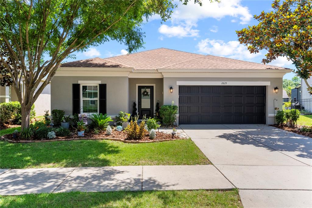 a front view of a house with a yard and garage