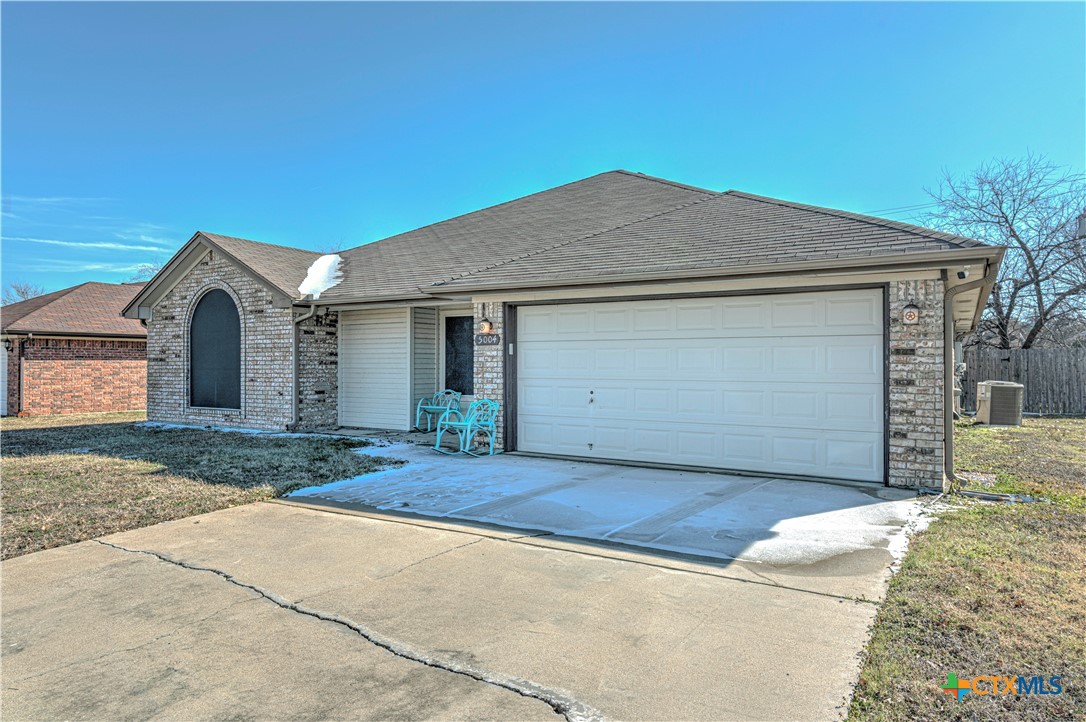 5004 Sunrise Street Killeen, TX 76542 - Photo 2 of 29 a front view of a house with a yard and garage