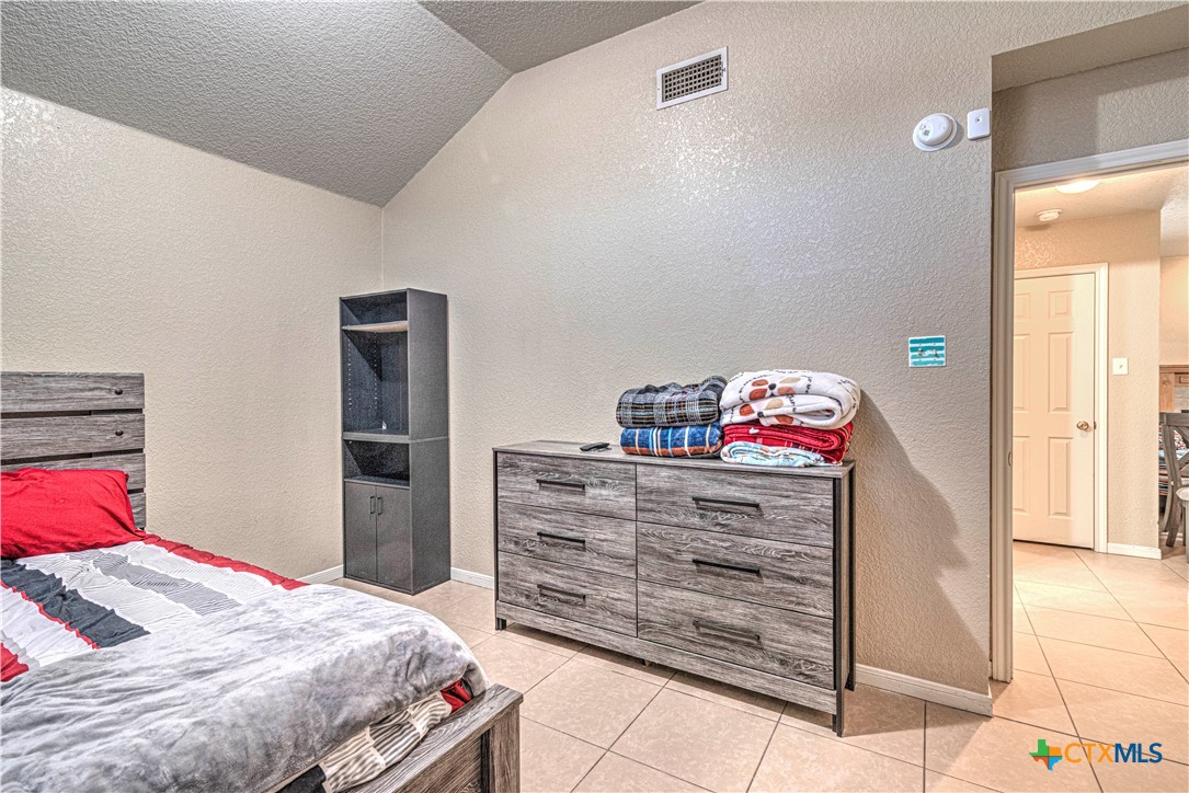 5004 Sunrise Street Killeen, TX 76542 - Photo 23 of 29 a bedroom with a bed and a dresser