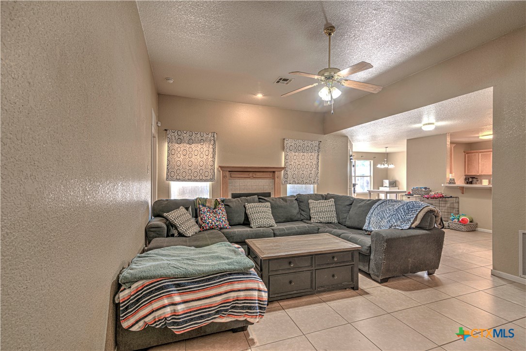 5004 Sunrise Street Killeen, TX 76542 - Photo 6 of 29 a living room with furniture and a chandelier
