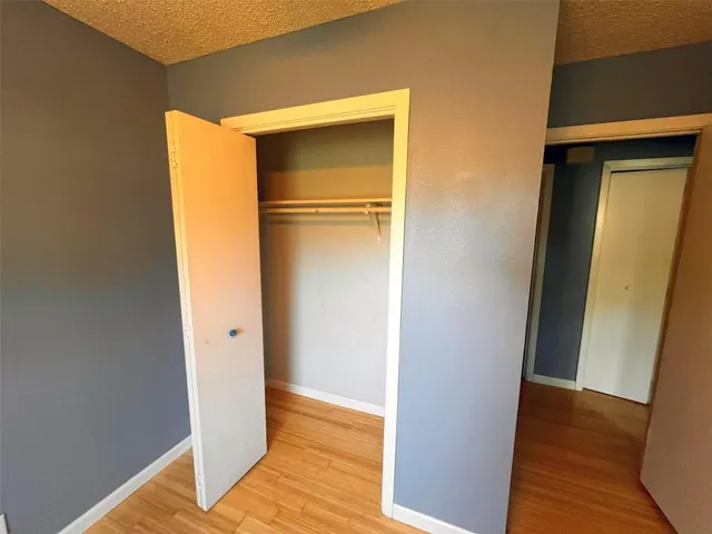 a view of walk in closet with wooden floor