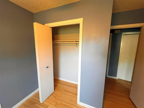 a view of walk in closet with wooden floor