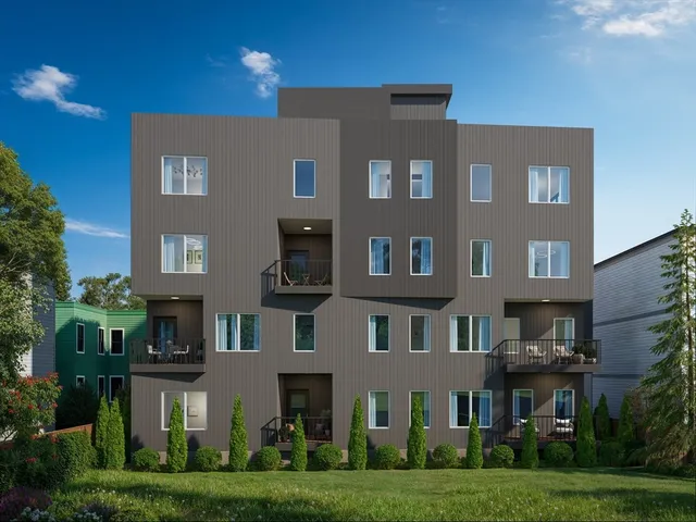 a front view of residential houses with yard and green space