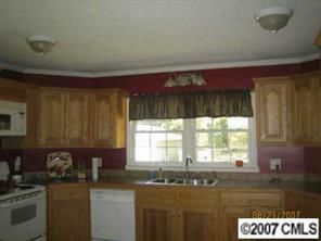 1936 New Salem Road Monroe, NC 28110 - Photo 5 of 7 a kitchen with granite countertop a sink window and cabinets