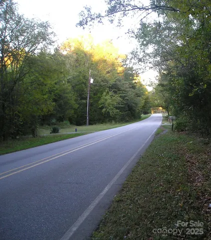 a view of a field with trees in background