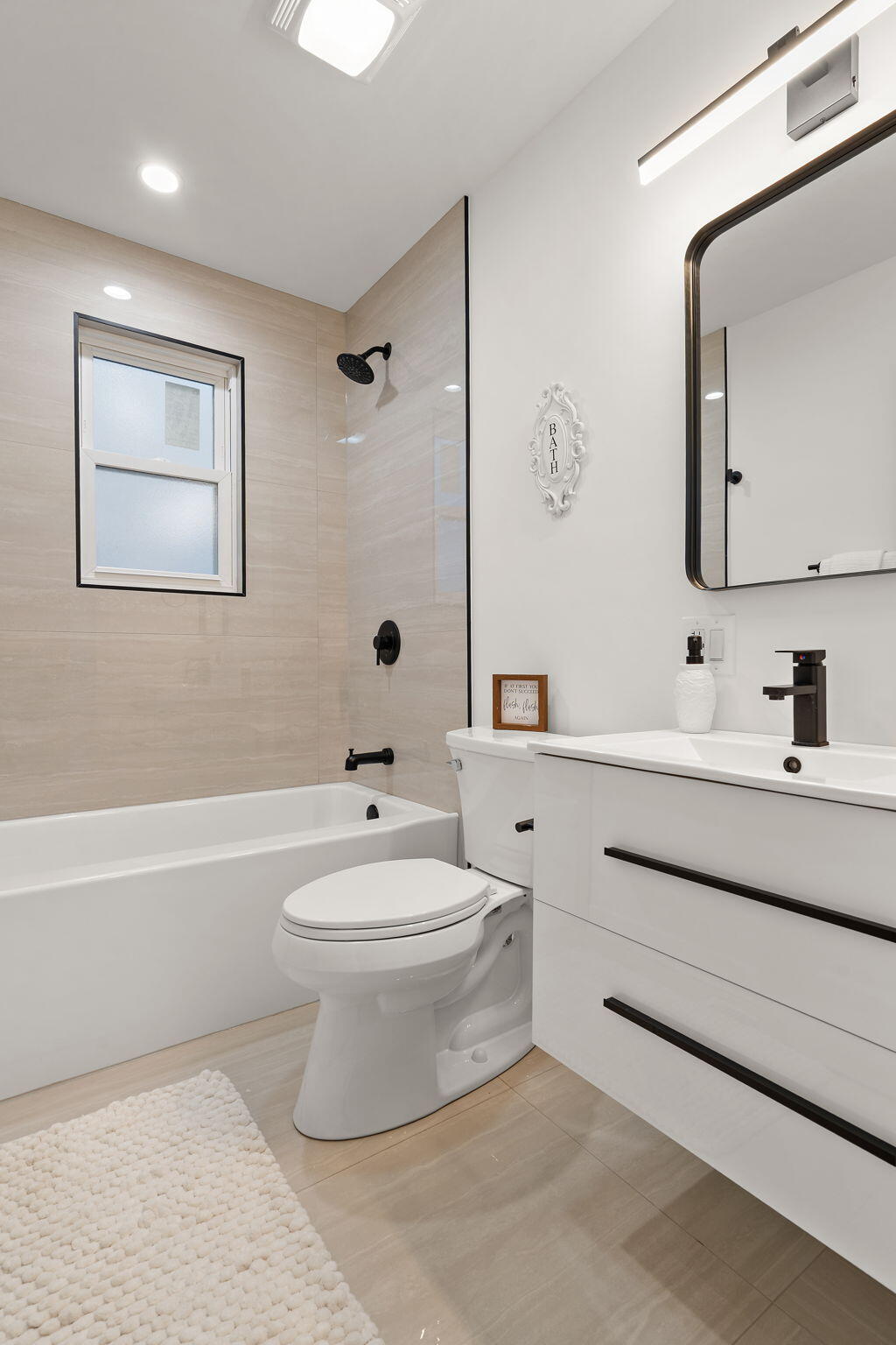 2017 Clark Street Whiting, IN 46394 - Photo 15 of 37 a bathroom with a toilet a sink a mirror a bathtub and vanity