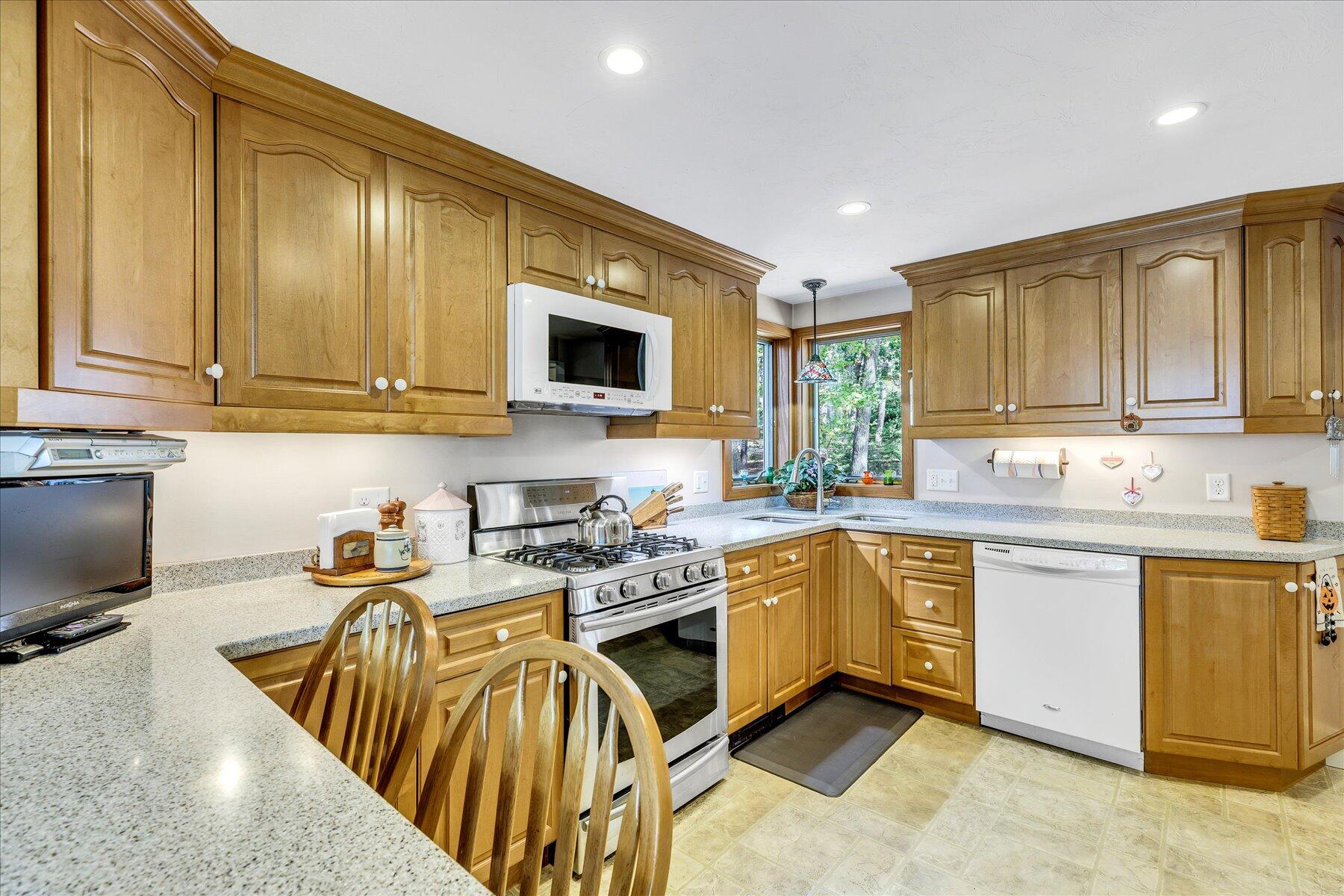 248 Wheeler Road Mashpee, MA 02649 - Photo 13 of 76 a kitchen with stainless steel appliances granite countertop wooden cabinets a stove top oven a sink and dishwasher