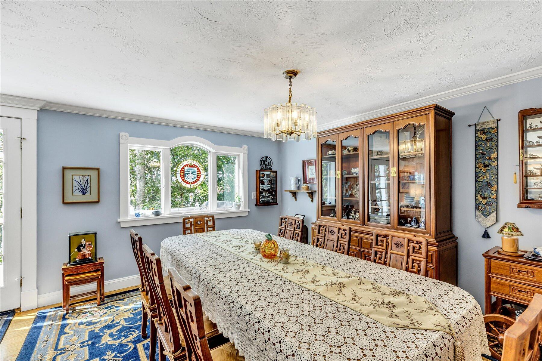 248 Wheeler Road Mashpee, MA 02649 - Photo 17 of 76 a view of a dining room with furniture a chandelier and wooden floor